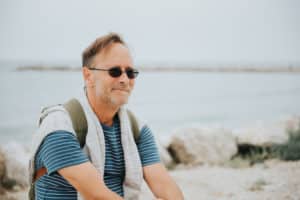 Outdoor portrait of happy middle age man enjoying nice sunny day on the beach