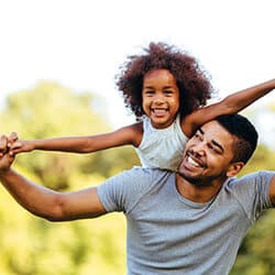 Father and daughter playing in a park